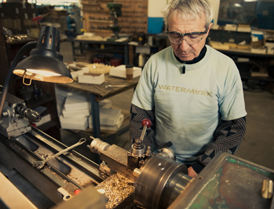 worker making brass fixture.