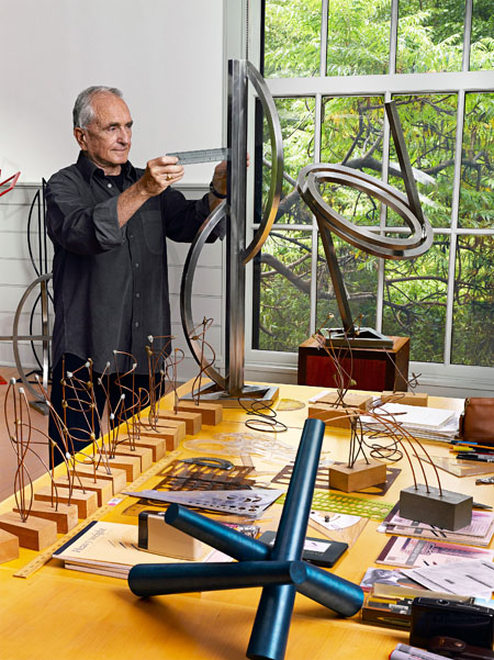 Sculptor Arthur Carter working in his studio. 