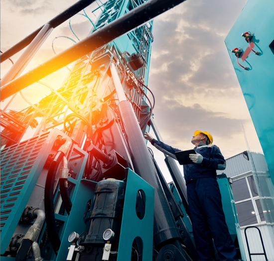 Worker wearing a hard-hat using machinery